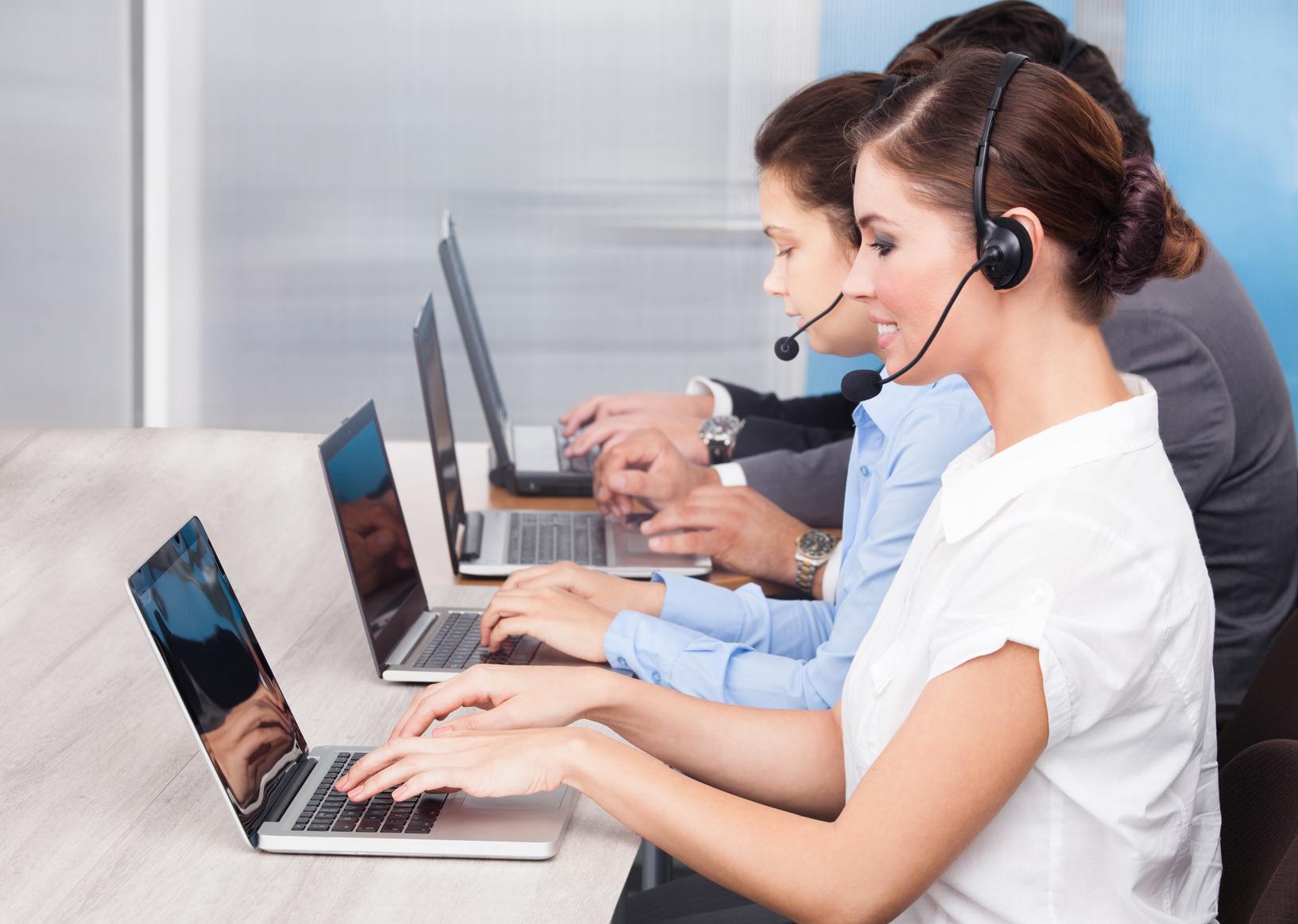 Modern call center teamwork with professionals collaborating efficiently in a bright workspace.