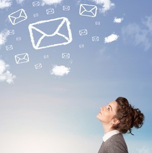 young woman gazing at sky, reflecting on messages symbolized by floating envelopes and clouds.