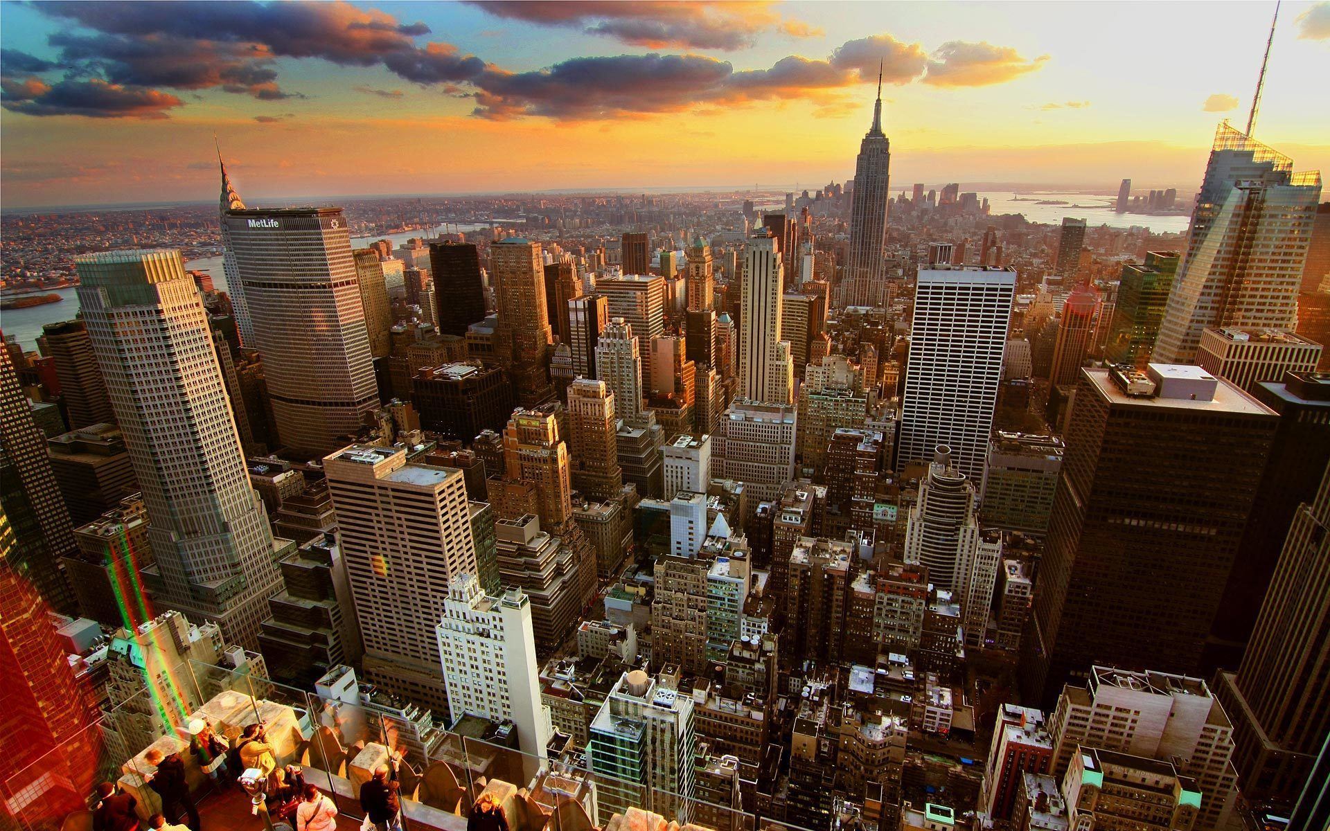 Breathtaking sunset view of New York Citys skyline with the Empire State Building shining.