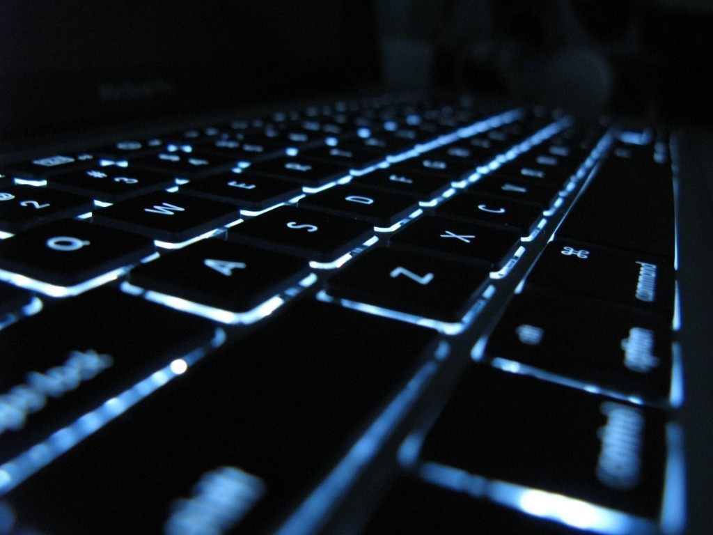 sleek, illuminated laptop keyboard showcasing modern design and functionality with blue backlighting.