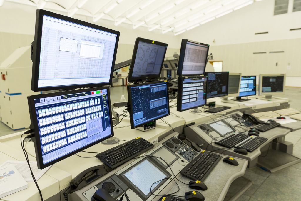 Modern control room for efficient user access management with vibrant data displays and ergonomic controls.