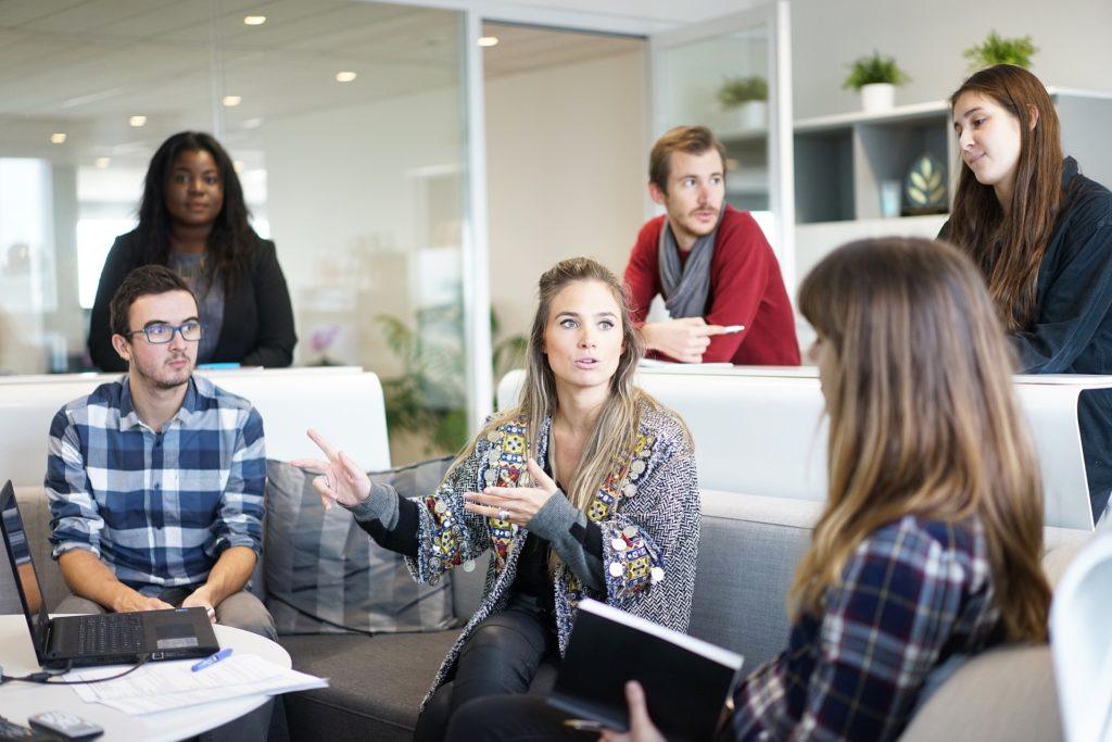 engaged team brainstorming in a bright, modern office with lively discussions and open collaboration.