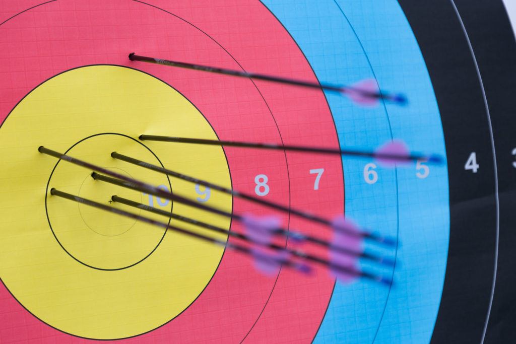 Grouped arrows in a vibrant archery target showcase precision and archer skill.