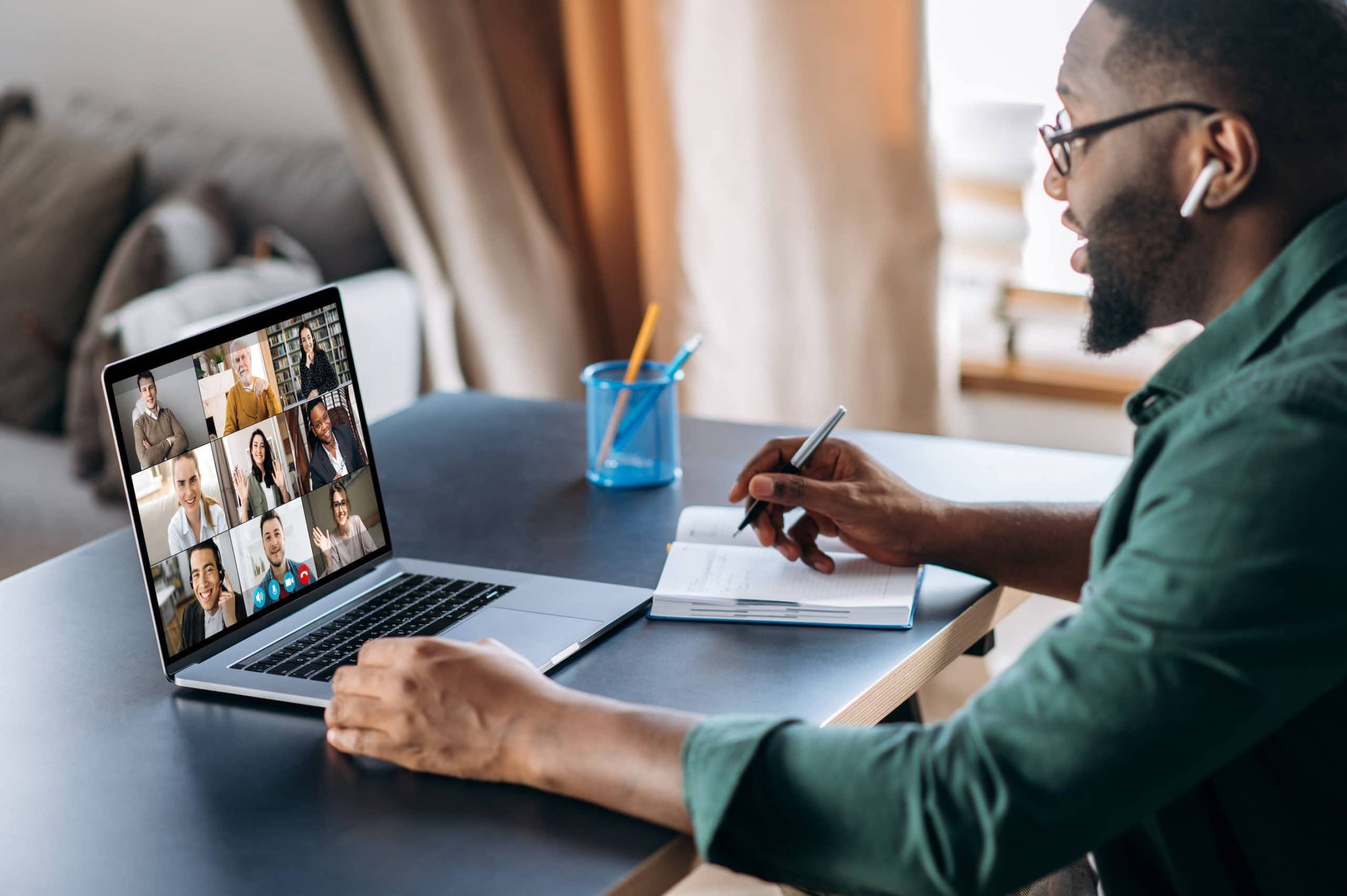 a man sitting at a table with a laptop