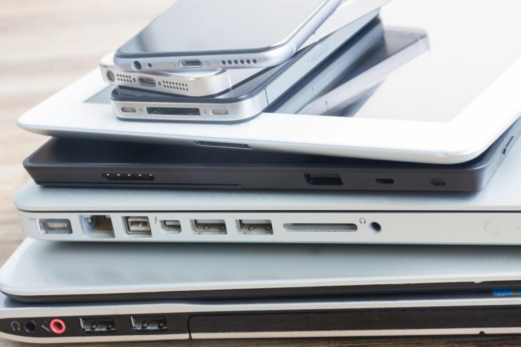 stylish stack of smartphones, tablet, and laptop showcasing modern technology integration.