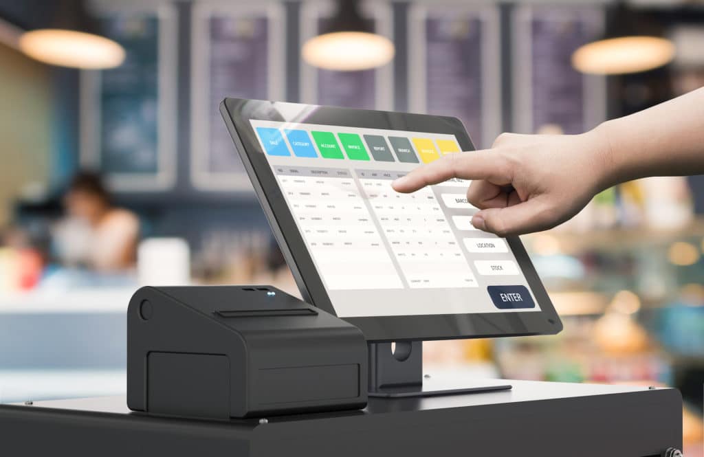 user engages with a modern pos touchscreen tablet in a bustling café setting.