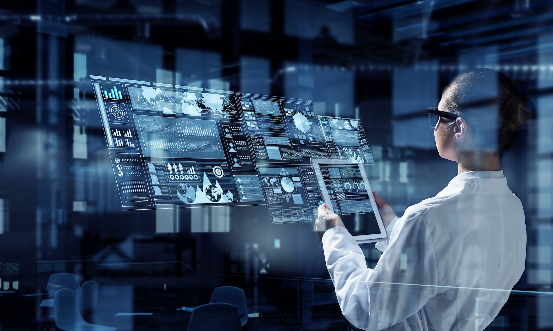 a man in a lab coat is looking at a computer screen