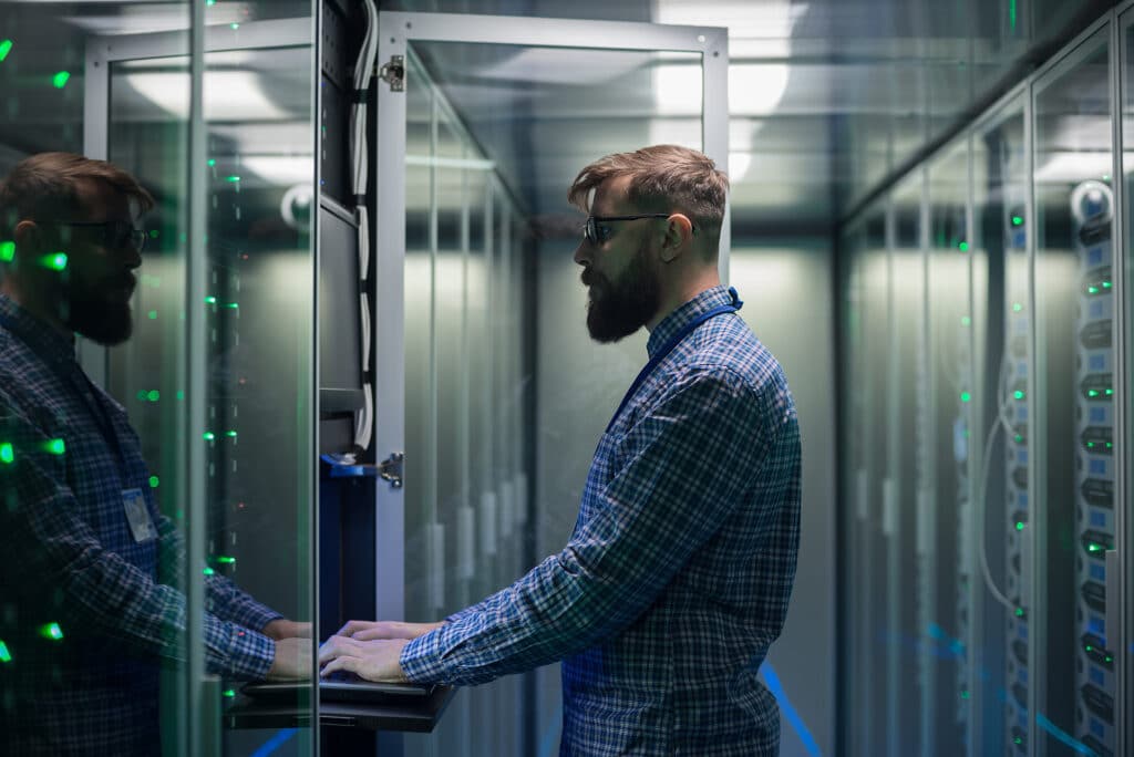 technician monitors server performance in a modern, high-tech data center.