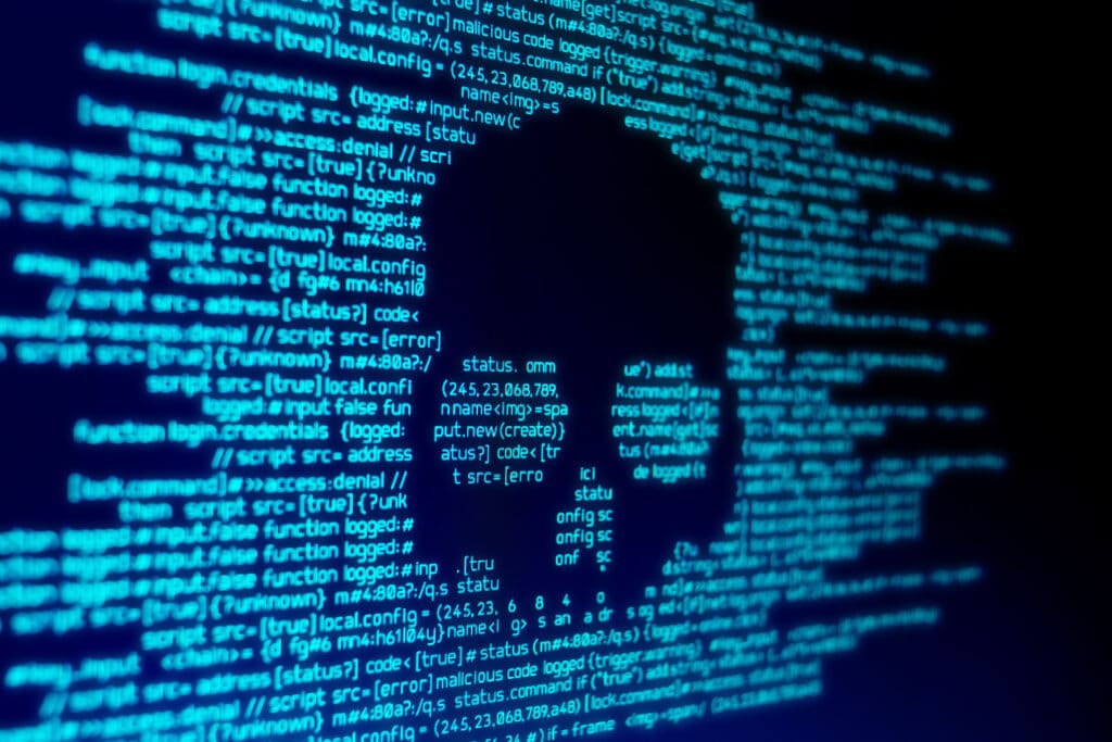 skull icon amidst code symbolizes digital security threats and the risks of cybercrime.