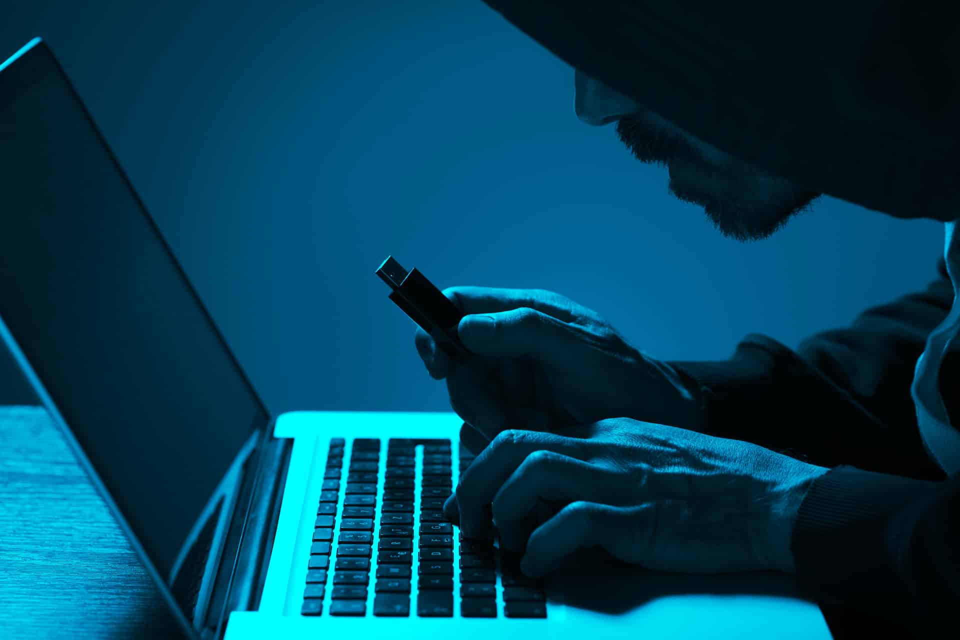 a man sitting in front of a laptop computer