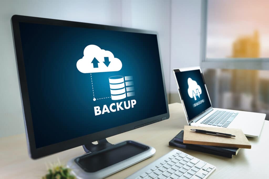 cloud backup and data transfer in a modern workspace with dual devices and seamless connectivity.