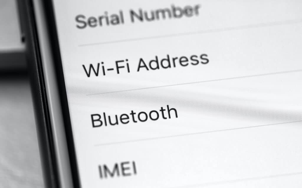 close-up of iphone settings displaying mac address and bluetooth options in moscow, august 2020.