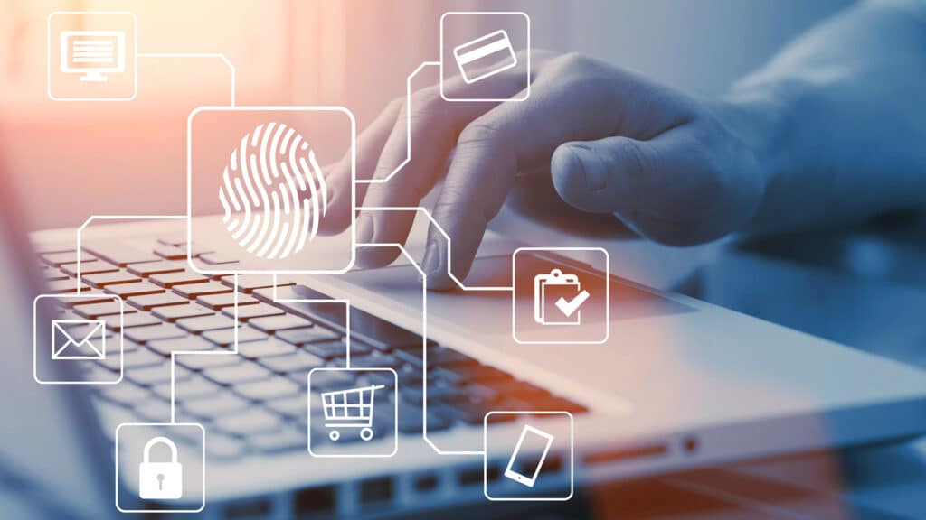 close-up of a hand using a laptop, highlighting biometric security icons and digital interactions.